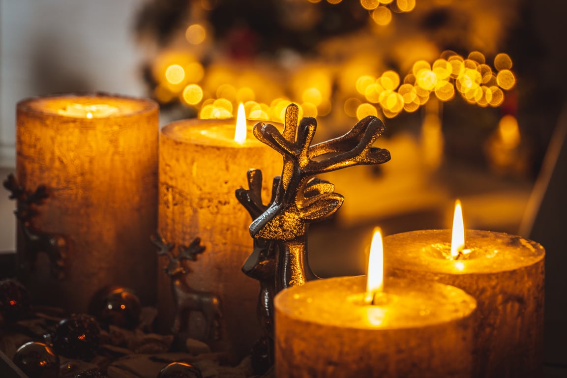 Lighted Candle on Black Metal Candle Holder